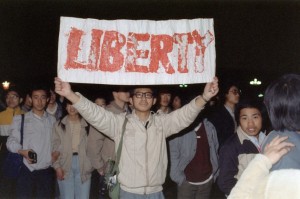 A student displays a banner with one of the slogans chanted by the crowd of some 200,000 pouring into Tiananmen Square on April 22, 1989, one week after the funeral of the reform-minded Communist Party leader Hu Yaobang. Six weeks later, tanks and troops would crush the student demonstration. (Catherine Henriette/AFP/Getty Images)