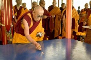 His Holiness the Dalai Lama preparing the base for the Kalachakra Sand Mandala that will be constructed by Monks of Namgyal Monastery on the first day of the Kalachakra Teachings in Leh, Ladakh, J&K, India on July 3, 2014. Photo/Manuel Bauer