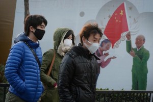 Shoppers walk past a "Chinese Dream' poster in Beijing in 2013 (AFP Photo/Mark Ralston)