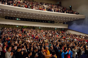 A full house of over 2000 people standing as His Holiness the Dalai Lama arrives at Showa University Hall at the start of his teaching in Tokyo, Japan on April 12, 2015. Photo/Tenzin Jigmey