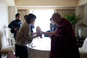 A Japanese journalist offering His Holiness the Dalai Lama a gift of gratitude after their interview in Gifu, Japan on April 8, 2015. Photo/Tenzin Jigmey