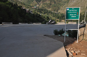 A sign board depicting Potala Road, the road from Mcleod Ganj to Dharamshala. Photo: Tibet.net