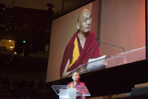 Founder of the Friends of the Dalai, Lama Ven. Tenzin Dhonden, welcoming the audience and thanking His Holiness the Dalai Lama during celebrations honoring His Holiness's 80th birthday at the Honda Center in Anaheim, California, USA on July 5, 2015. Photo/Tenzin Choejor/OHHDL