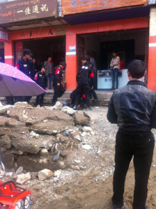 Photo showing the Tibetan youth being pinned down by police.