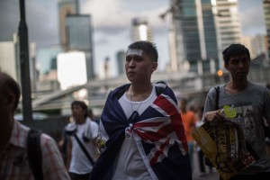 A protester wears the colonial Hong Kong flag around his shoulders as he attends a pro-democracy rally in Hong Kong on July 1, 2015, traditionally a day of protest which also marks the anniversary of the handover from Britain to China in 1997, under a "one country, two systems" agreement. Tens of thousands joined a pro-democracy march on the anniversary of Hong Kong's handover to China on July 1 in what organisers said was a chance to work out the movement's next step as momentum wanes. AFP PHOTO / ANTHONY WALLACE        (Photo credit should read ANTHONY WALLACE/AFP/Getty Images)