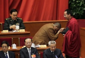 Tudeng Kezhu, a Tibetan delegate, touches the hand of Gyaltsen Norbu, the 11th Panchen Lama and a delegate, with his forehead during the opening session of the Chinese People's Political Consultative Conference (CPPCC) at the Great Hall of the People in Beijing, March 3, 2015. REUTERS/Jason Lee/Files