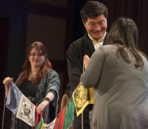 June Rule (left) and Lizette Ayala, seniors at Booker T. Washington High School, presented Lobsang Sangay with prayer flags made by the school’s Tibet Club during his talk Friday at the Bush Center.