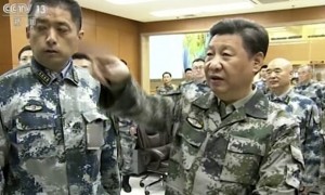 Xi Jinping, right, in military uniform, seen on state broadcaster CCTV touring the Chinese army’s joint forces battle command centre. Photograph: AP 