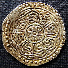 Tibetan undated silver tangka (2nd half of the 18th century) with eight times the syllable "dza" in vartula script,reverse. The Tibetan "dza" can be used to transcribe the Sanskrit syllable "ja" which can be short for "jaya" ("victorious"). The central design of the coin is a wheel with eight spokes which is a reference to the Buddhist "dharmacakra" ("wheel of law"). Thus the design and the inscription of the coin combined may have the meaning "victorious wheel of law", or, in a wider sense "victorious teaching of Buddha". (image for representation)