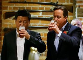 China's President Xi Jinping and Britain's Prime Minister David Cameron drink a pint of beer during a visit to the the Plough pub on Oct. 22, 2015, in Princes Risborough, England Kirsty Wigglesworth—WPA Pool/Getty Images