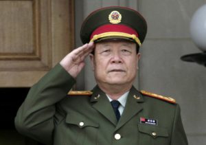 China's then Central Military Commission former Vice Chairman General Guo Boxiong stands at attention during the playing of the national anthem before a meeting at the Pentagon in Washington in this July 18, 2006 file photo.  REUTERS/Yuri Gripas/File Photo - RTSJHRV