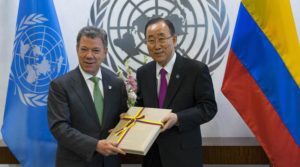 FILE - In this Monday, Sept. 19, 2016 file photo President Juan Manuel Santos of Colombia, left, presents a copy of a peace agreement that was forged in his country to United Nations Secretary-General Ban Ki-moon during a meeting at the United Nations headquarters. Colombian President Juan Manuel Santos has won Nobel Peace Prize it was announced on Friday Oct. 7, 2016. (AP Photo/Craig Ruttle)
