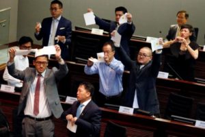Pro-democracy lawmakers tear apart ballots as they boycott the process of electing council chairman at the Legislative Council in Hong Kong, China October 12, 2016. REUTERS/Bobby Yip