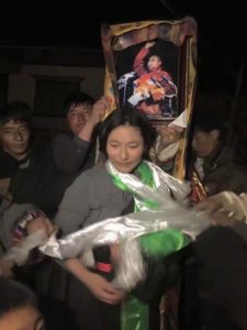Dolma Tso being offered traditional Tibetan ceremonial scarves by local Tibetans.