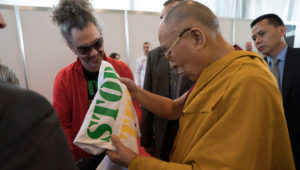 His Holiness the Dalai Lama looking at a t-shirt offered by Latvian singer Horens Stalbe after his meeting with Tibet supporters from the Baltic States in Riga, Latvia on September 24, 2017. Photo by Tenzin Choejor